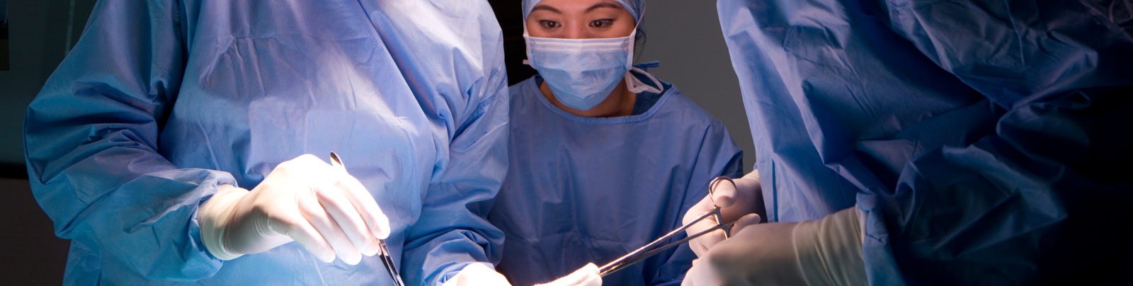 Three surgeons working on a lung transplant patient.